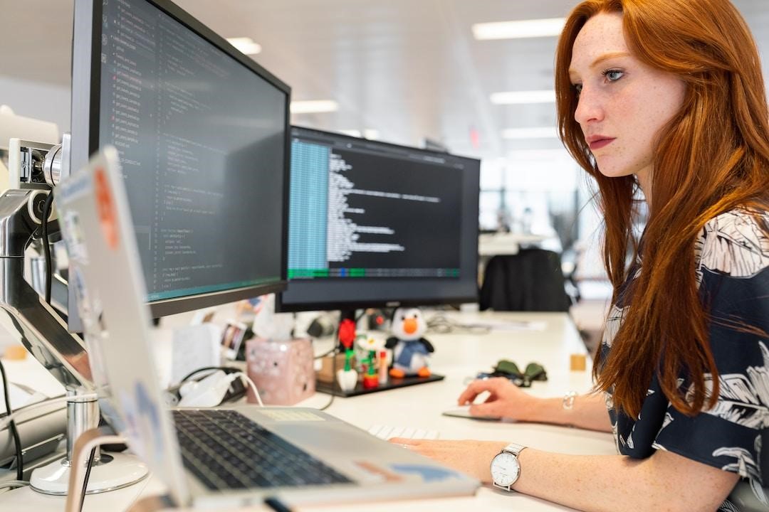 A woman in an office researching PSA software on her computer